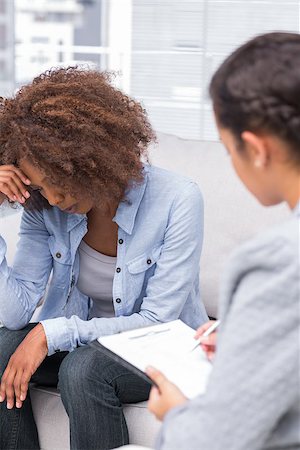 simsearch:6109-08203204,k - Upset woman crying on the sofa with therapist making notes Stock Photo - Budget Royalty-Free & Subscription, Code: 400-06880052