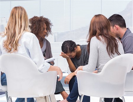 Psychologist taking notes while woman crying at group therapy Stock Photo - Budget Royalty-Free & Subscription, Code: 400-06880082