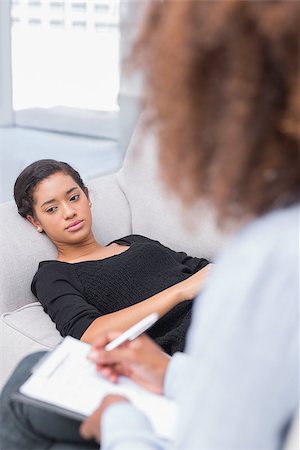 simsearch:400-06932767,k - Woman lying on therapists couch looking unhappy as therapist is writing Stock Photo - Budget Royalty-Free & Subscription, Code: 400-06880235