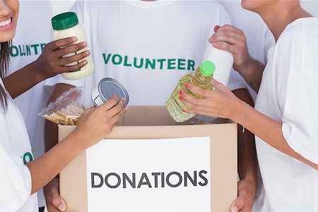 Group of volunteers putting food in donation box Stock Photo - Budget Royalty-Free & Subscription, Code: 400-06880342