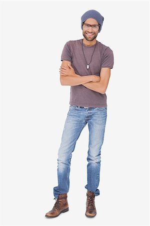 Stylish young man smiling at camera on white background Photographie de stock - Aubaine LD & Abonnement, Code: 400-06880457