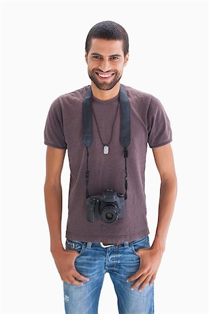 Handsome man with camera around his neck on white background Stock Photo - Budget Royalty-Free & Subscription, Code: 400-06880476