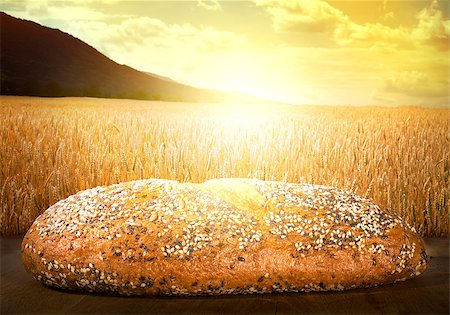 sunset meal - Bread and wheat cereal crops at sunset. Cereal crops on the background Stock Photo - Budget Royalty-Free & Subscription, Code: 400-06880887