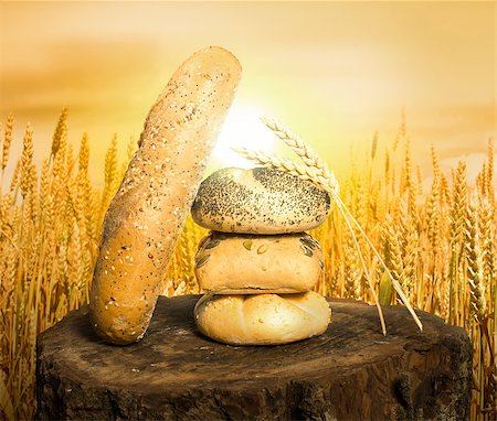 sunset meal - Bread and wheat cereal crops. Cereal crops on the background at sunset Stock Photo - Budget Royalty-Free & Subscription, Code: 400-06880902