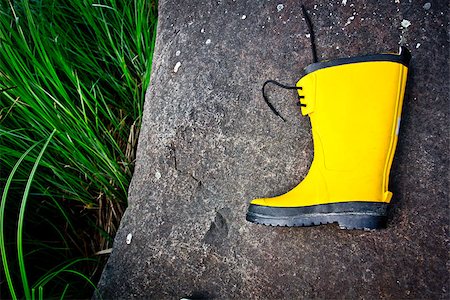 A yellow boot lying on a stone Foto de stock - Royalty-Free Super Valor e Assinatura, Número: 400-06881110