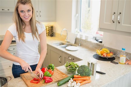 person chopping carrots - Woman chopping vegetables in kitchen Stock Photo - Budget Royalty-Free & Subscription, Code: 400-06881661