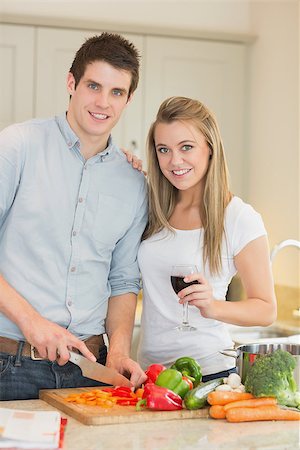 simsearch:400-04044662,k - Smiling couple preparing dinner in kitchen Stock Photo - Budget Royalty-Free & Subscription, Code: 400-06881693