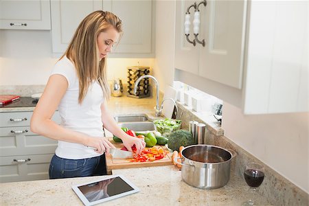 person chopping carrots - Young woman working in the kitchen with tablet computer Stock Photo - Budget Royalty-Free & Subscription, Code: 400-06881718