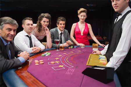 people sitting in casino - People are sitting at the blackjack  table smiling at the casino Stock Photo - Budget Royalty-Free & Subscription, Code: 400-06881906