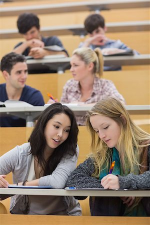 simsearch:400-06803206,k - Students sitting in a lecture hall while studying while using a tablet pc and talking Stock Photo - Budget Royalty-Free & Subscription, Code: 400-06881957