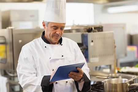 Chef using his digital tablet in the kitchen Stock Photo - Budget Royalty-Free & Subscription, Code: 400-06882094