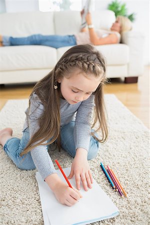 Little girl sitting at the floor drawing Stock Photo - Budget Royalty-Free & Subscription, Code: 400-06882184