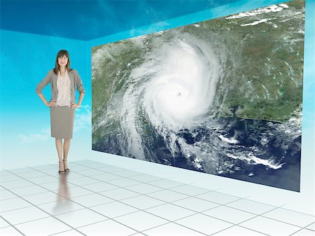 Businesswoman standing next to futuristic screen showing weather on a satellite map Stock Photo - Budget Royalty-Free & Subscription, Code: 400-06882187