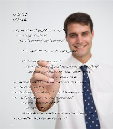 Smiling businessman writing in sql language on a transparent board Stock Photo - Budget Royalty-Free & Subscription, Code: 400-06882745