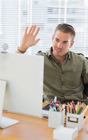 simsearch:400-06885294,k - Creative business employee waving in a modern office during a videocall Stockbilder - Microstock & Abonnement, Bildnummer: 400-06883005