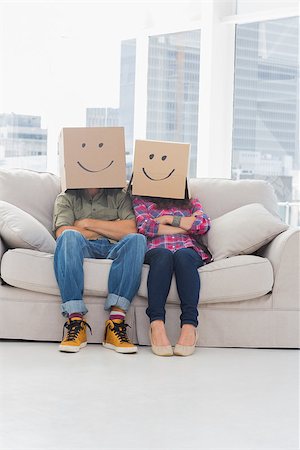 Funny workers wearing boxes on their heads with smiley faces on a couch Stock Photo - Budget Royalty-Free & Subscription, Code: 400-06883048