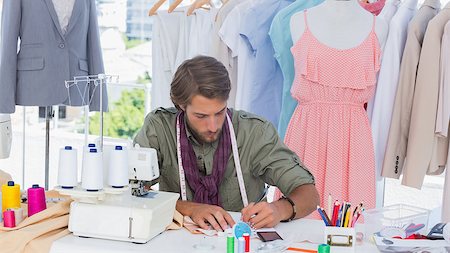 simsearch:400-06885526,k - Fashion designer drawing on a desk in front of clothes Stock Photo - Budget Royalty-Free & Subscription, Code: 400-06883143