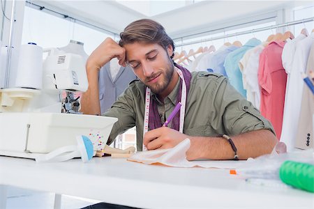 simsearch:400-06885526,k - Smiling fashion designer working at his desk in a creative office Stock Photo - Budget Royalty-Free & Subscription, Code: 400-06883166