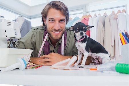 simsearch:400-06885526,k - Fashion designer looking at camera with his chihuahua sitting on desk Stock Photo - Budget Royalty-Free & Subscription, Code: 400-06883170