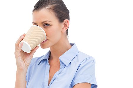 simsearch:400-06883455,k - Pretty businesswoman drinking coffee looking at the camera Photographie de stock - Aubaine LD & Abonnement, Code: 400-06883484