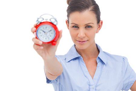 simsearch:400-06883455,k - Businesswoman showing alarm clock and looking at the camera Photographie de stock - Aubaine LD & Abonnement, Code: 400-06883490