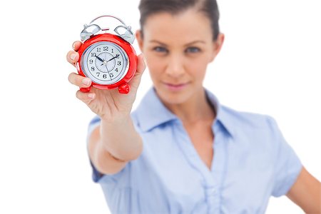 simsearch:400-06883455,k - Businesswoman holding alarm clock and looking at the camera Photographie de stock - Aubaine LD & Abonnement, Code: 400-06883491