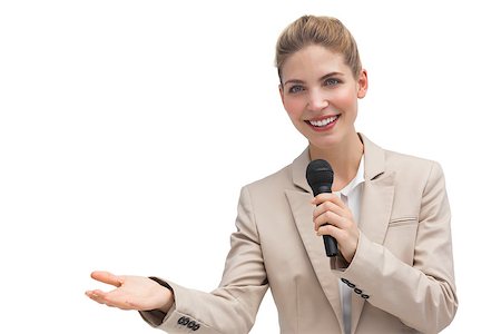 simsearch:400-06883455,k - Businesswoman holding microphone and smiling at the camera Photographie de stock - Aubaine LD & Abonnement, Code: 400-06883626