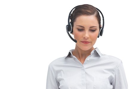 A businesswoman with headset looking down and thinking Stock Photo - Budget Royalty-Free & Subscription, Code: 400-06883659