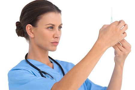 doctor preparing shot - Serious surgeon holding up a syringe and checking it on white background Stock Photo - Budget Royalty-Free & Subscription, Code: 400-06883866