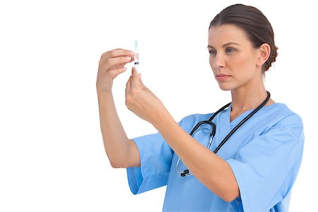 doctor preparing shot - Serious surgeon holding up needle and checking it on white background Stock Photo - Budget Royalty-Free & Subscription, Code: 400-06883868