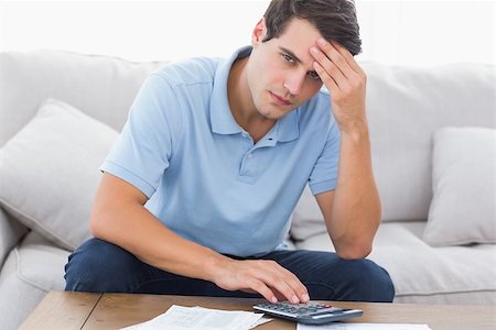 simsearch:400-07333928,k - Portrait of an anxious man doing his accounts Stock Photo - Budget Royalty-Free & Subscription, Code: 400-06890001