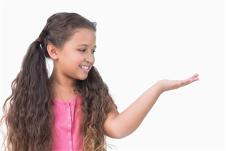 simsearch:400-06890095,k - Smiling little girl presenting something on white background Stock Photo - Budget Royalty-Free & Subscription, Code: 400-06890081