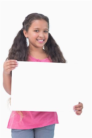 simsearch:400-06890095,k - Little girl holding and presenting sign at camera on white background Stock Photo - Budget Royalty-Free & Subscription, Code: 400-06890083