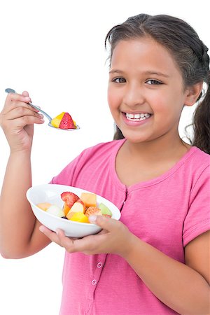 Happy little girl eating fruit salad on white background Photographie de stock - Aubaine LD & Abonnement, Code: 400-06890114