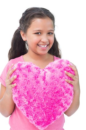 simsearch:400-06885115,k - Little girl holding cushion in the shape of a heart on white background Photographie de stock - Aubaine LD & Abonnement, Code: 400-06890117