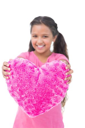 simsearch:400-06890095,k - Little girl showing cushion in the shape of a heart on white background Stock Photo - Budget Royalty-Free & Subscription, Code: 400-06890118