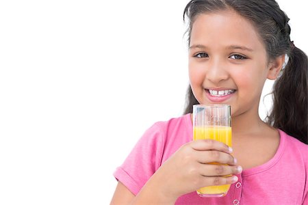 simsearch:400-06890095,k - Cheerful little girl drinking orange juice on white background Stock Photo - Budget Royalty-Free & Subscription, Code: 400-06890111