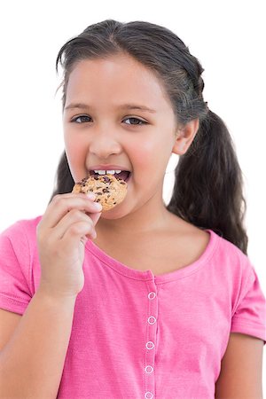 simsearch:400-06890095,k - Smiling little girl eating a cookie on white background Stock Photo - Budget Royalty-Free & Subscription, Code: 400-06890124