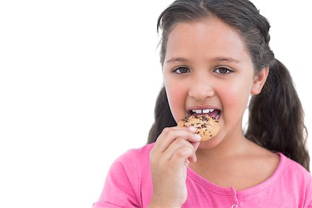 simsearch:400-06890095,k - Happy little girl eating a cookie on white background Stock Photo - Budget Royalty-Free & Subscription, Code: 400-06890125