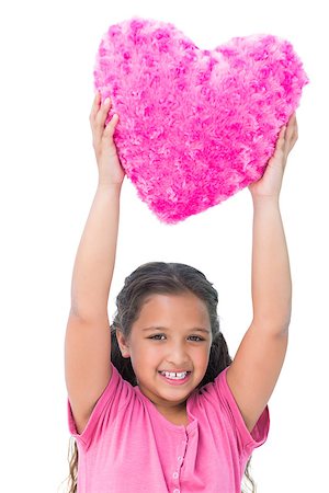 simsearch:400-06885104,k - Smiling little girl holding cushion in the shape of a heart on white background Stock Photo - Budget Royalty-Free & Subscription, Code: 400-06890120