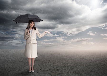 Sophisticated businesswoman holding an umbrella during stormy weather Stock Photo - Budget Royalty-Free & Subscription, Code: 400-06890137