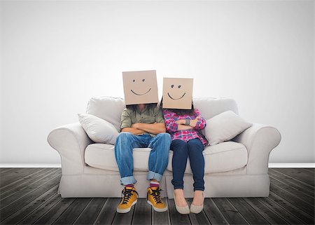 Funny couple wearing boxes on their head on a couch Stock Photo - Budget Royalty-Free & Subscription, Code: 400-06890187