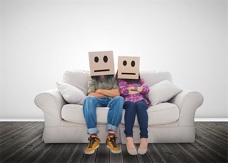 Couple sitting on couch with cardboard boxes over their head with smiley faces Stock Photo - Budget Royalty-Free & Subscription, Code: 400-06890205