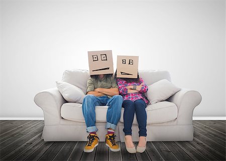 Couple wearing humorous boxes on their head on a couch Stock Photo - Budget Royalty-Free & Subscription, Code: 400-06890206