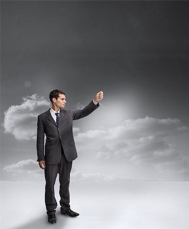 Businessman holding out his arm with clouds on the background Stock Photo - Budget Royalty-Free & Subscription, Code: 400-06890247