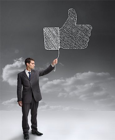Businessman holding a giant thumb up from the social network Stock Photo - Budget Royalty-Free & Subscription, Code: 400-06890256