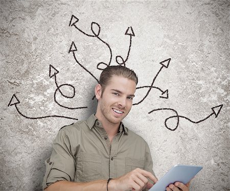 simsearch:400-06889355,k - Cheerful man using a tablet with drawings of arrows on the background Stockbilder - Microstock & Abonnement, Bildnummer: 400-06890298