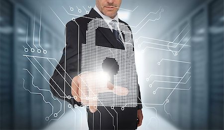 simsearch:400-06890458,k - Businessman selecting a futuristic padlock with a data center on the background Stock Photo - Budget Royalty-Free & Subscription, Code: 400-06890467