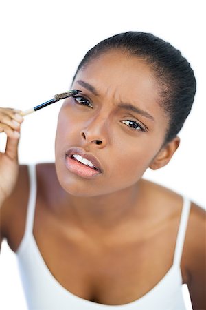 simsearch:400-06890736,k - Beautiful woman putting mascara on her eyelash on white background Stock Photo - Budget Royalty-Free & Subscription, Code: 400-06890704