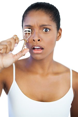 simsearch:400-06890736,k - Shocked woman using curler for her eyelash on white background Stock Photo - Budget Royalty-Free & Subscription, Code: 400-06890707